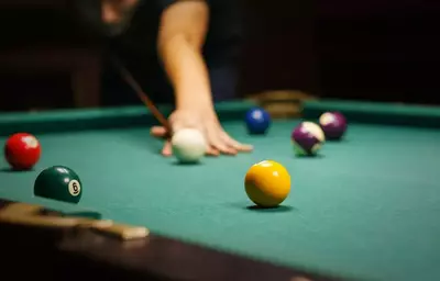 Guy playing pool