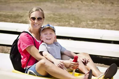 mom and son riding alpine coaster