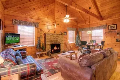 The beautiful living room with a fireplace at one of our 2 bedroom cabins in Gatlinburg.