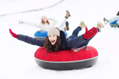 girl snow tubing in the smoky mountains