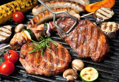 Meats and vegetables on the grill.