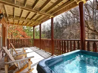 Rocking chairs and a hot tub on the deck of a Pigeon Forge cabin.