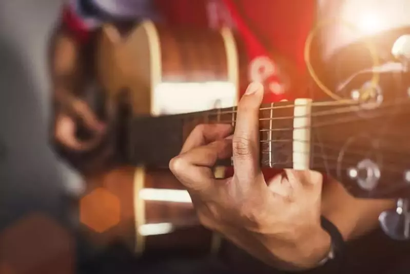 Man's hands playing on guitar at Smoky Mountains Songwriters Festival