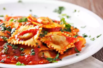 Ravioli covered in tomato sauce.