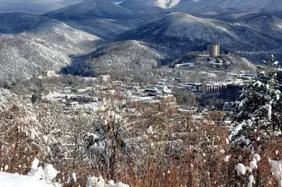 The city of Gatlinburg and the mountains covered in snow.