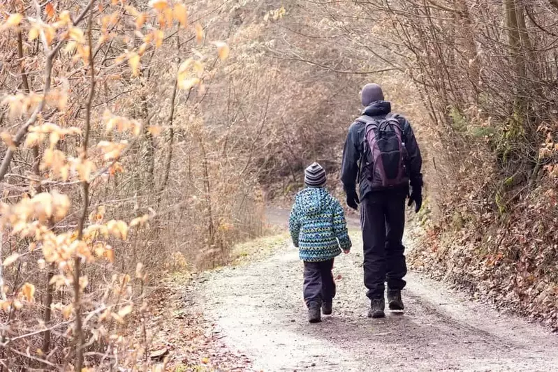 Father and son hiking in the winter.