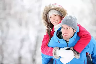 Happy couple hiking in the winter.