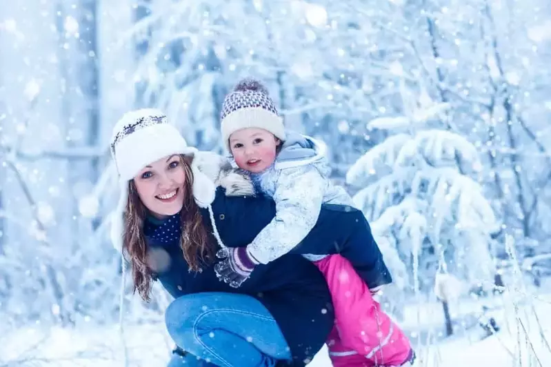 Mom and daughter having fun in the snow near our Gatlinburg vacation cabins.