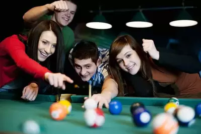 group enjoying Galtinburg family activities of playing pool