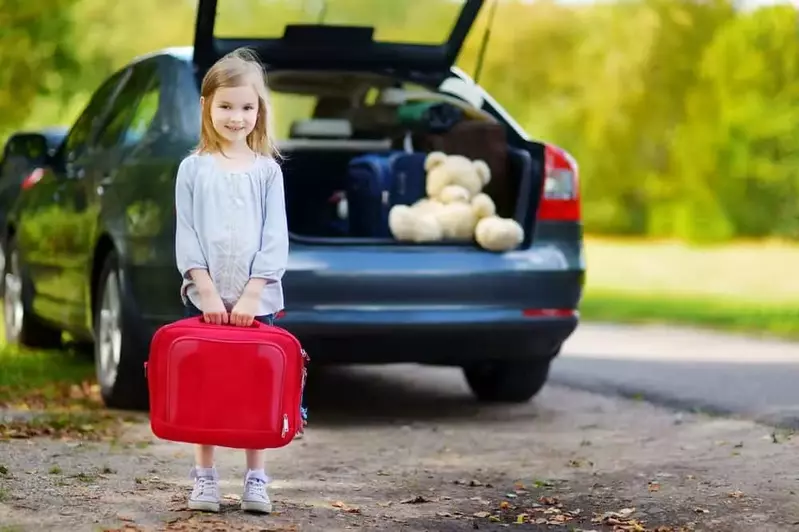 Little girl with a suitcase on her way to our Gatlinburg TN mountain cabins.