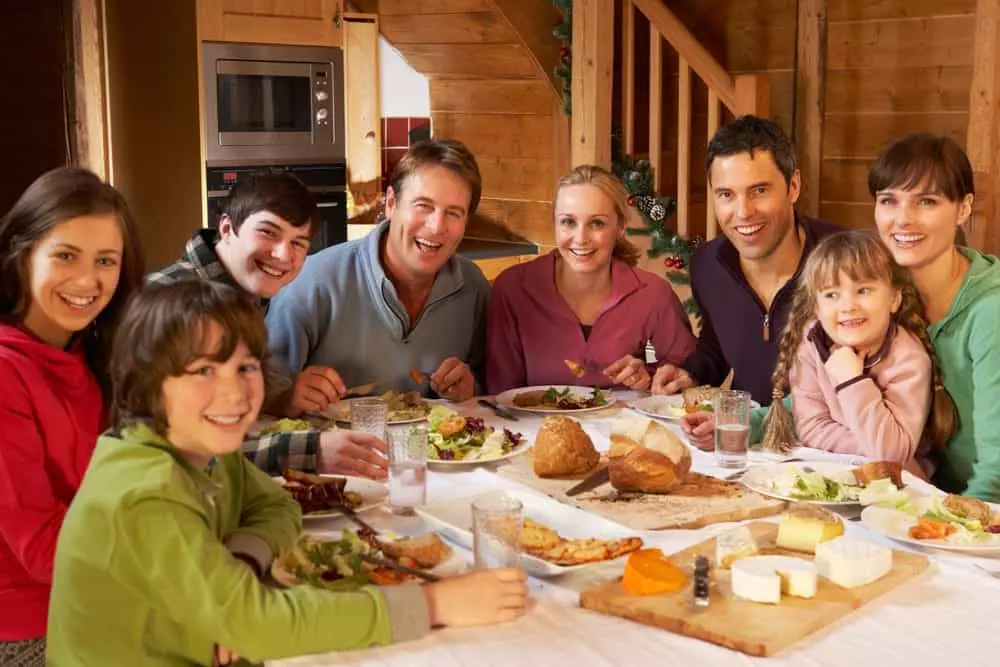 Two families enjoying a meal together on their affordable Gatlinburg cabin vacation
