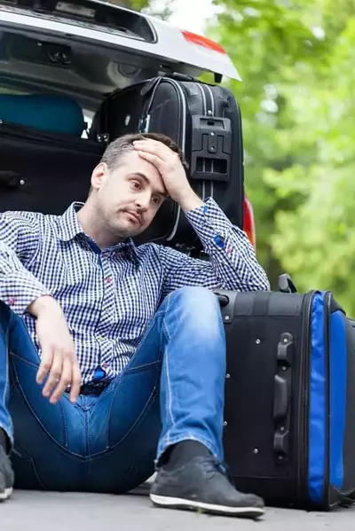man struggling to pack for Smoky Mountain cabin vacation